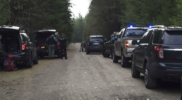 Police vehicles block the road after the shooting.