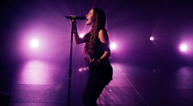 Worship artist Lauren Daigle performs at a concert.