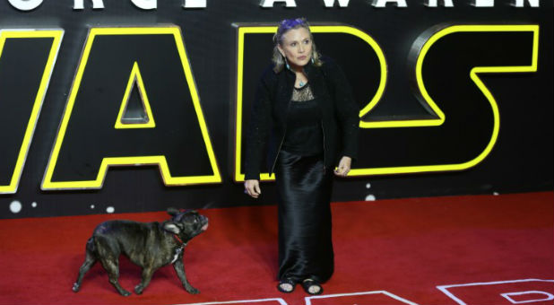 Carrie Fisher poses for cameras as she arrives at the European premiere of 'Star Wars, The Force Awakens' in Leicester Square, London.