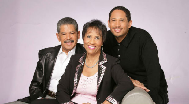 Fred Price Jr., right, with his father and mother.