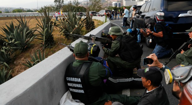 Soldiers take cover near the Generalisimo Francisco de Miranda Airbase